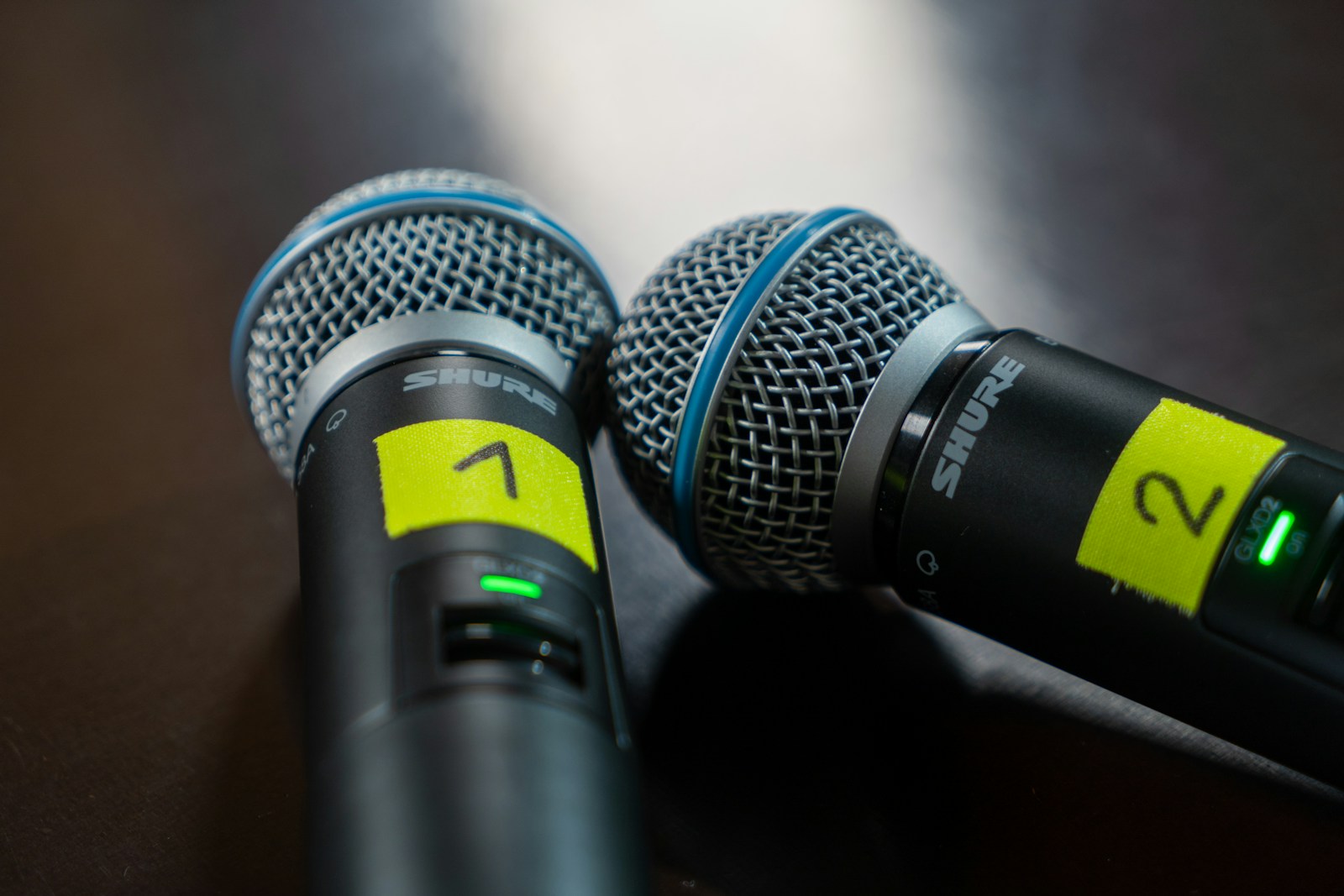 Photo by Mika Baumeister two microphones sitting next to each other on a table