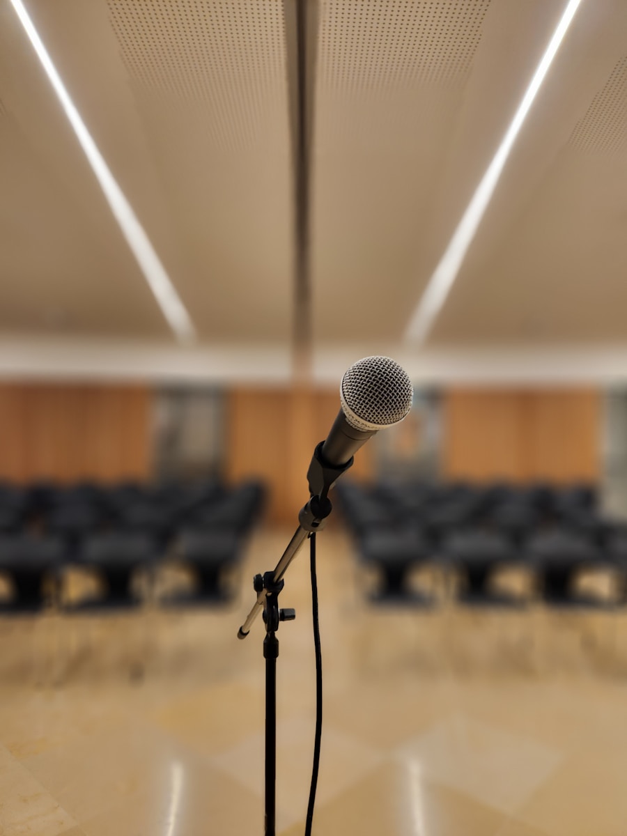 Photo by Benjamin Istanbuli a microphone on a stand in front of a room full of chairs