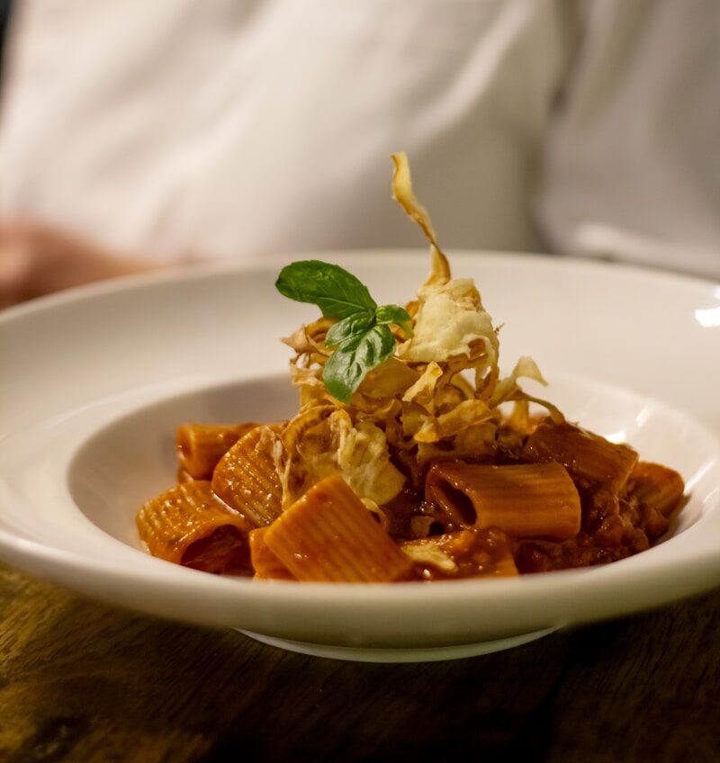 a plate of food with a chef in the background